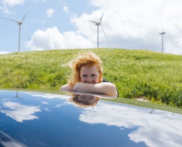 woman-looking-camera-getting-out-car-window-putting-hands-roof